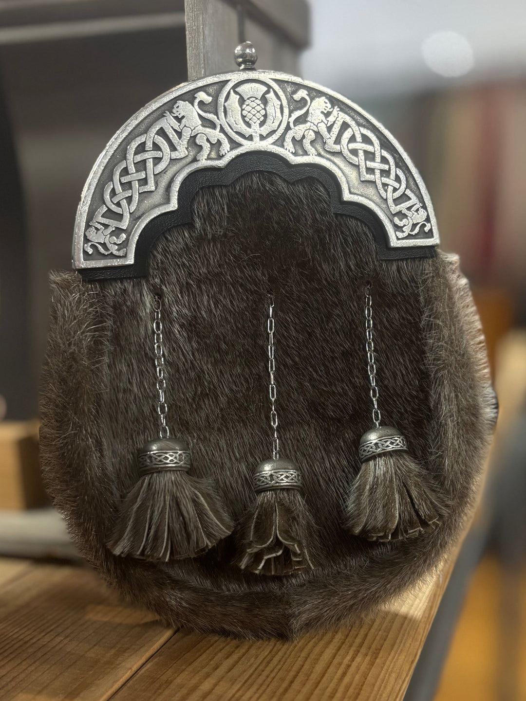 Traditional Scottish sporran with tassels on a wooden surface