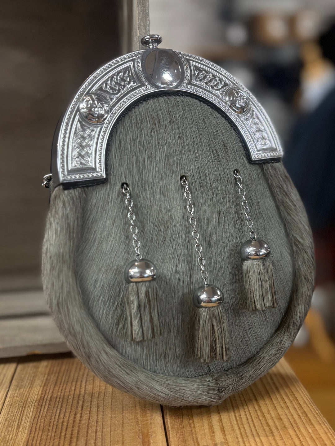 Traditional Scottish sporran with tassels on a wooden surface